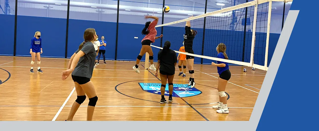 Female volleyball player spiking the ball